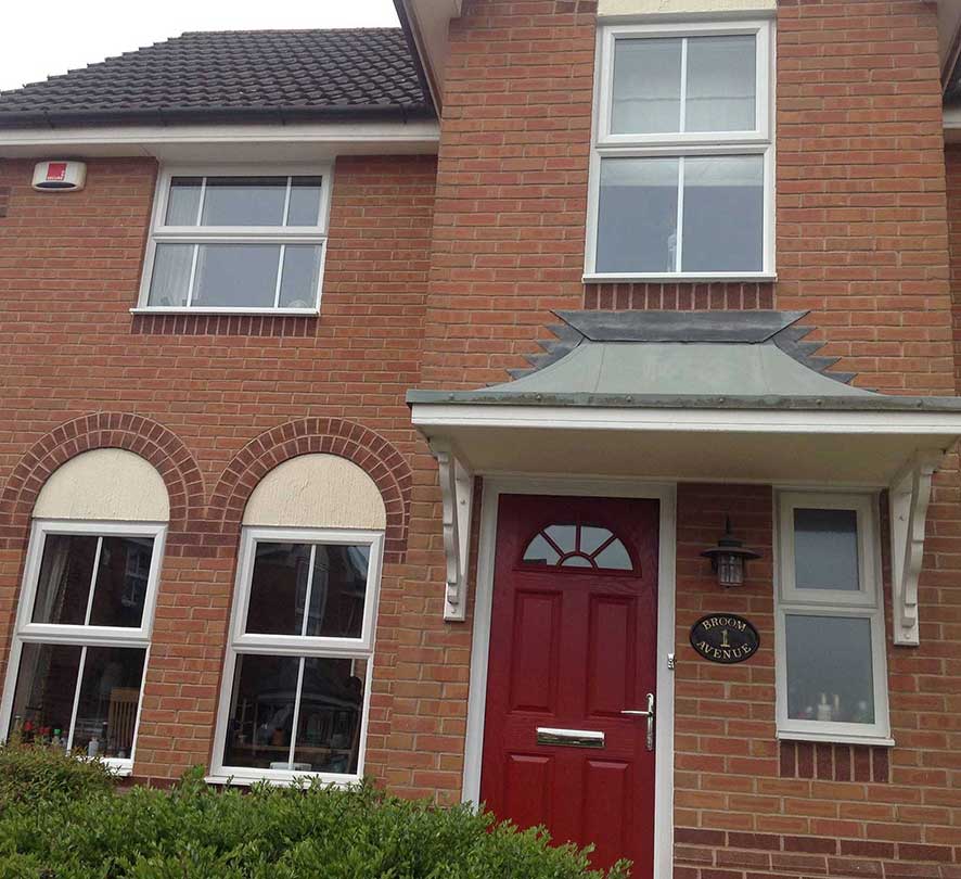 white framed windows with red door